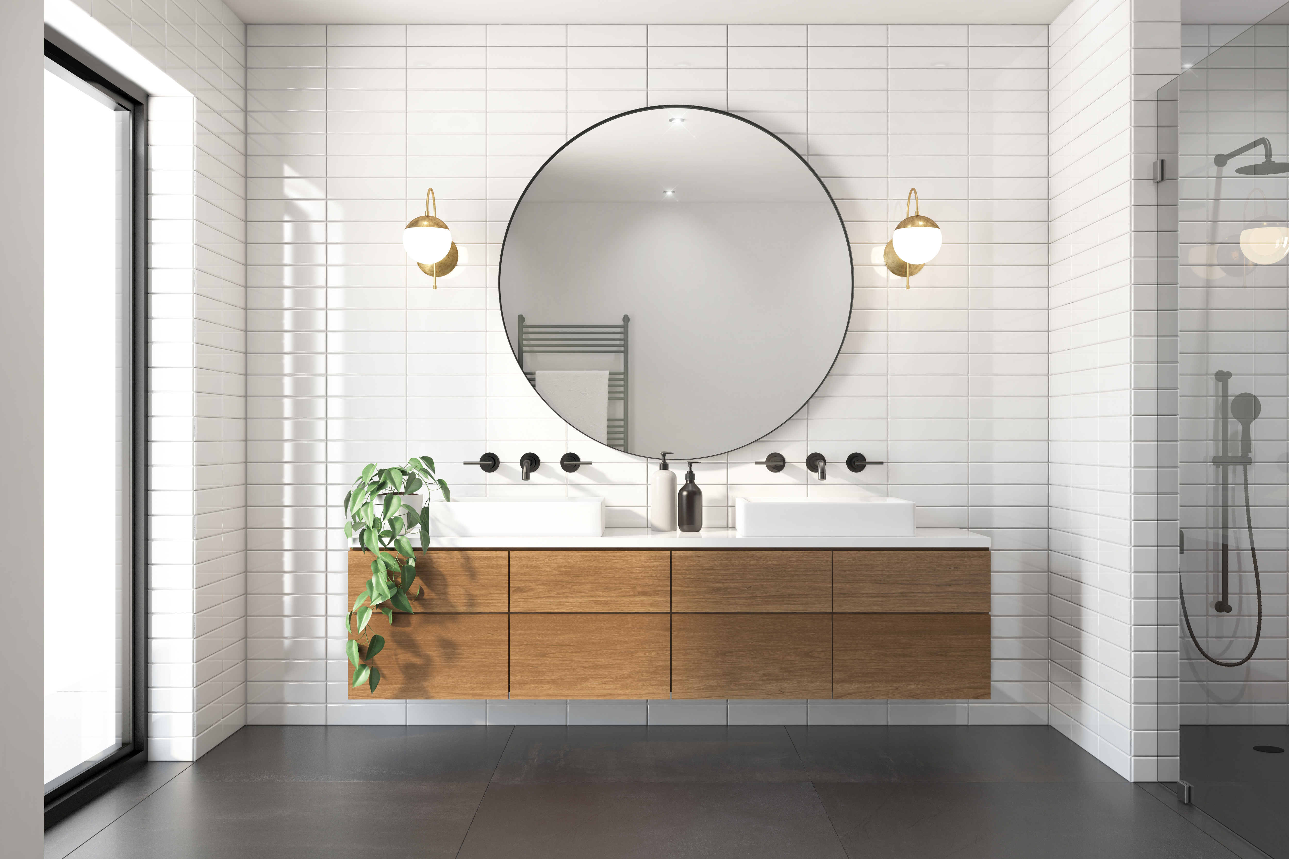 Bathroom with floating wood vanity, a large round mirror, and white tile walls.