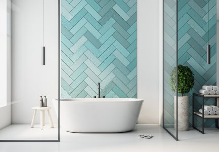 Modern turquoise bathroom interior with bath and self care products. Style and hygiene concept.