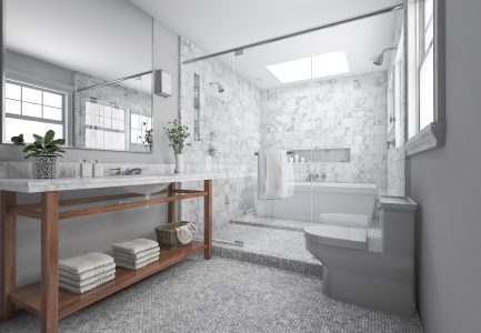Bright natural light in a gorgeous bathroom with glass enclosure and marble tile.
